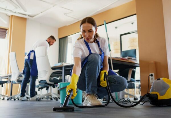 professional-cleaning-service-person-using-vacuum-cleaner-office_23-2150520594